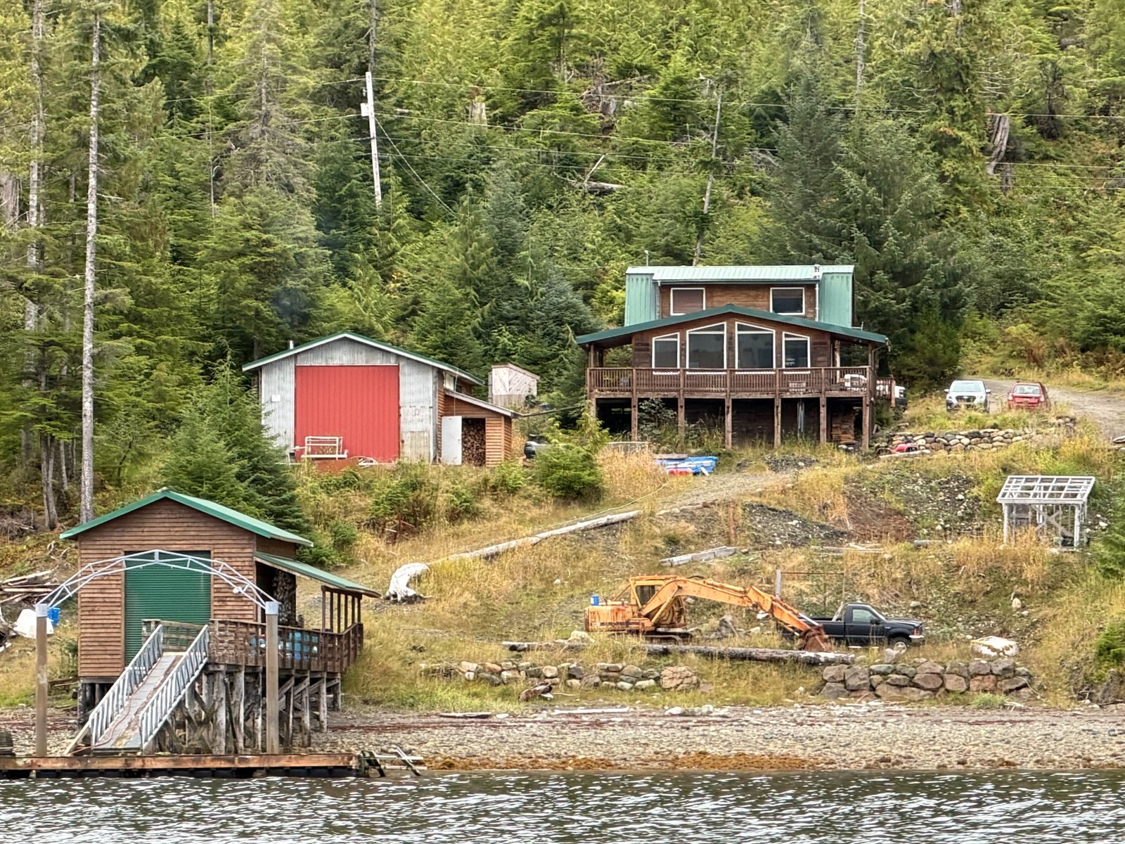 Existing house and outbuildings above the shore